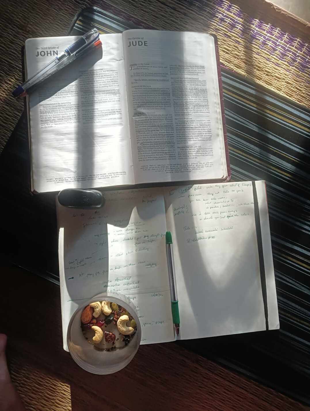 Desk with handwritten research notes, open books and a pen