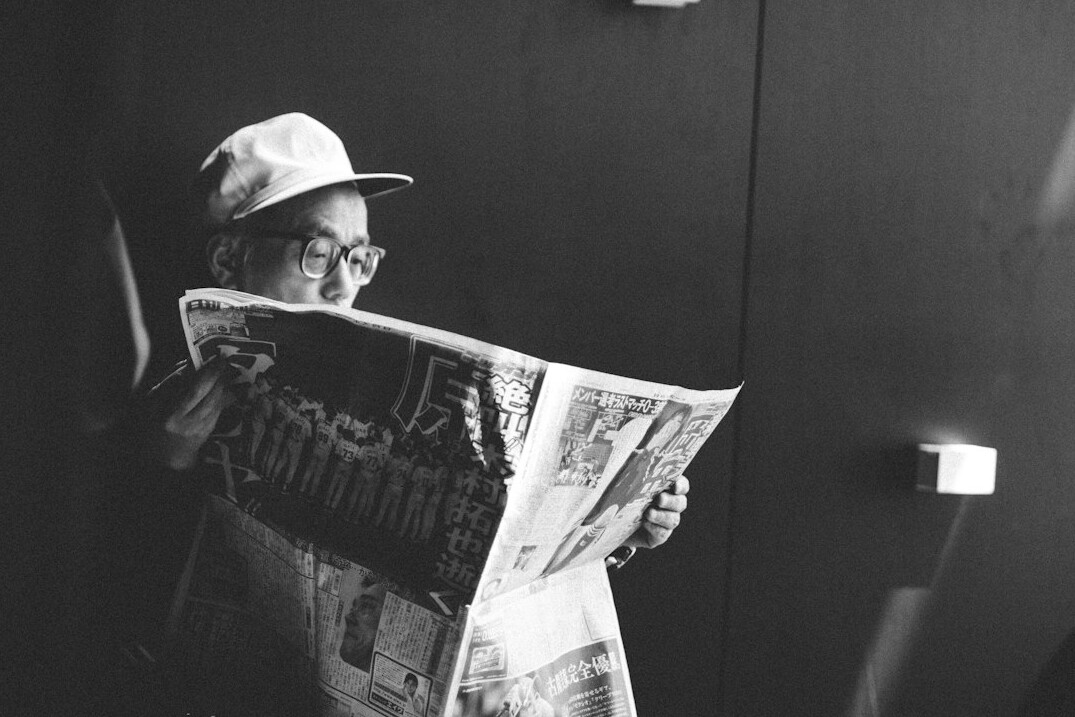 person reading newspaper